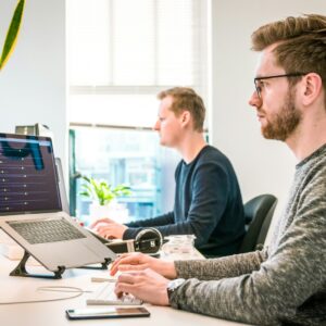 Two people at laptops in a calm workspace — IT Guy Reno